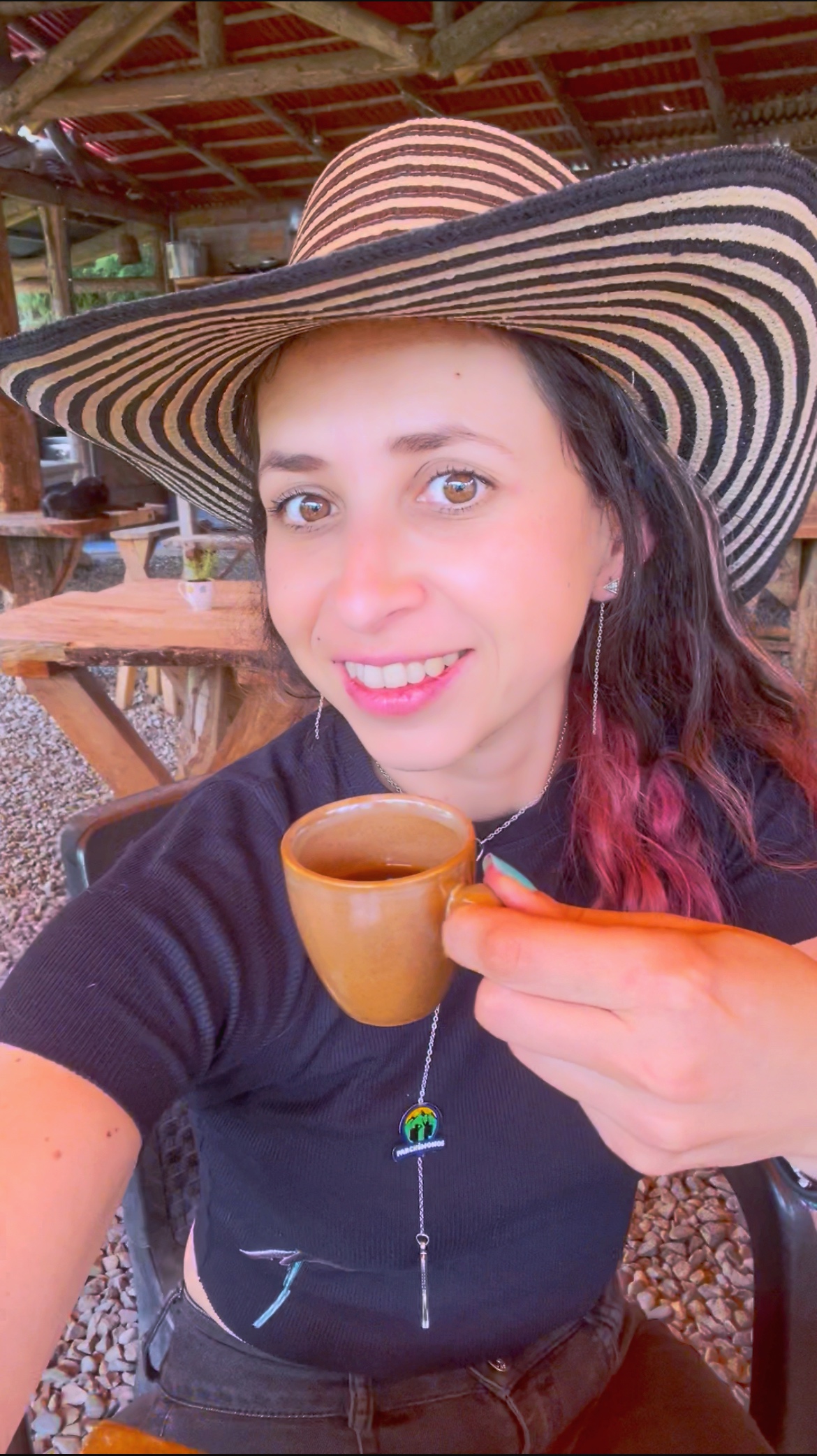 Turista disfrutando una taza de café recién hecho en una finca cafetera tradicional en Jardín, Antioquia, rodeado de naturaleza